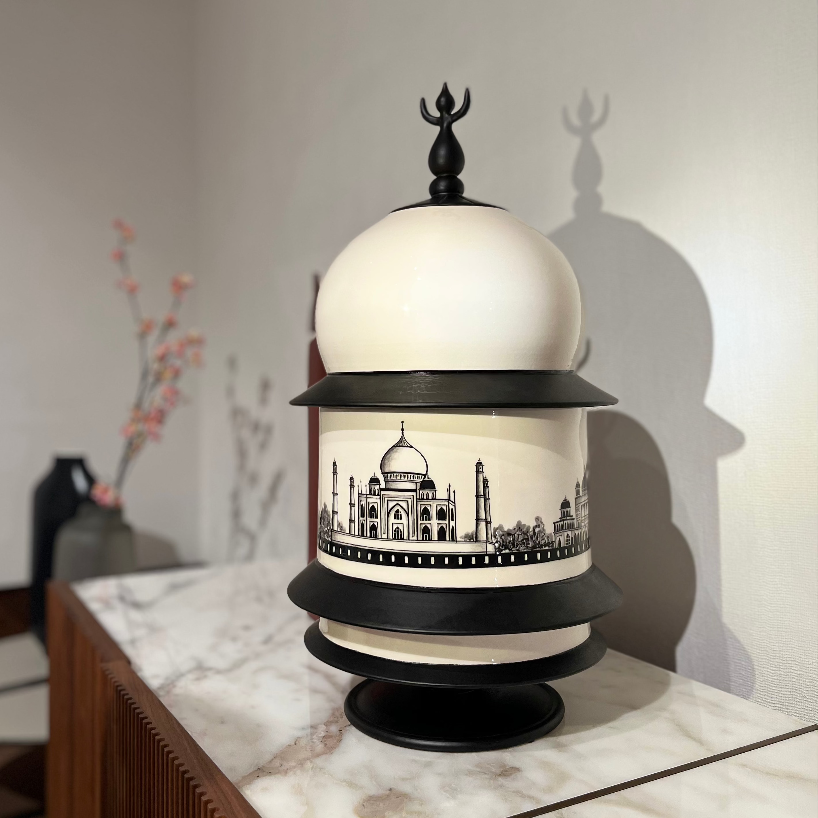 Decorative vase with Taj Mahal design on a marble surface